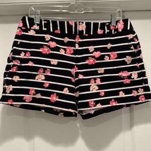 Black shorts with white stripes and pink floral